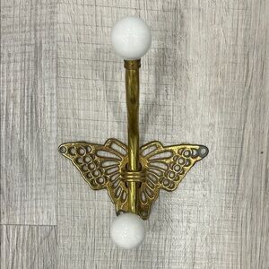 Vintage brass butterfly wall hook with porcelain knobs